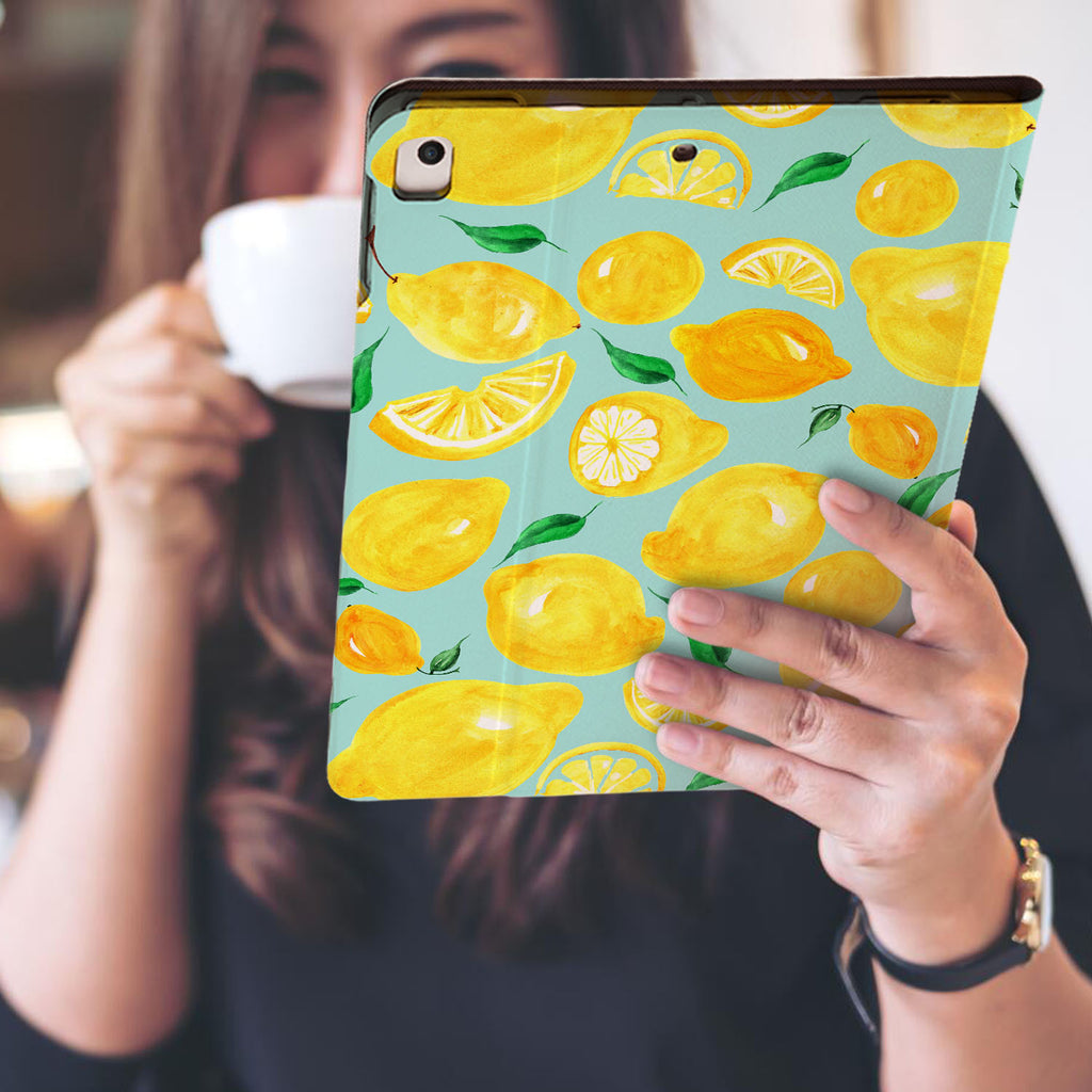 a girl is holding and viewing personalized iPad folio case with Fruit design
