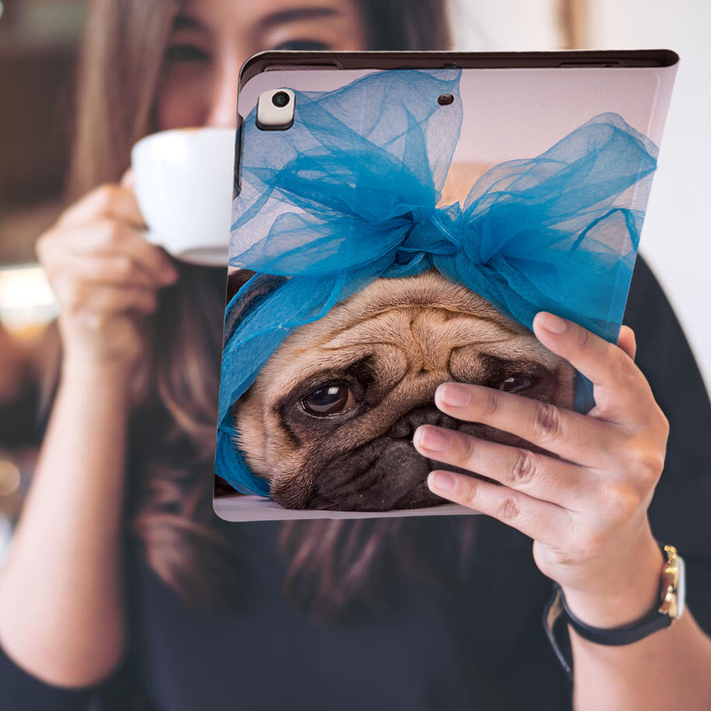 a girl is holding and viewing personalized iPad folio case with Dog design