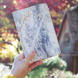 a girl holding personalized RFID blocking passport travel wallet with Marble design