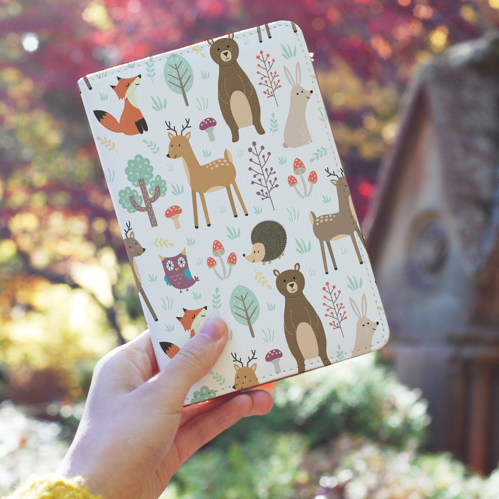 a girl holding personalized RFID blocking passport travel wallet with Forest Friends design