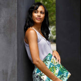 A yong girl holding personalized microsoft surface laptop case with Tropical Leaves design