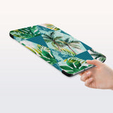a hand is holding the Personalized Samsung Galaxy Tab Case with Tropical Leaves design